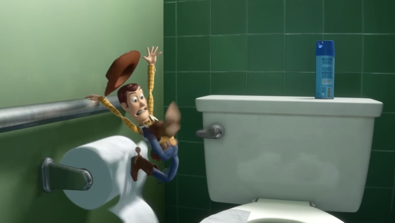 Woody slipping in a bathroom in Toy Story, arms stretched wide and his hat flying off, an exaggerated pose that reads in one frame