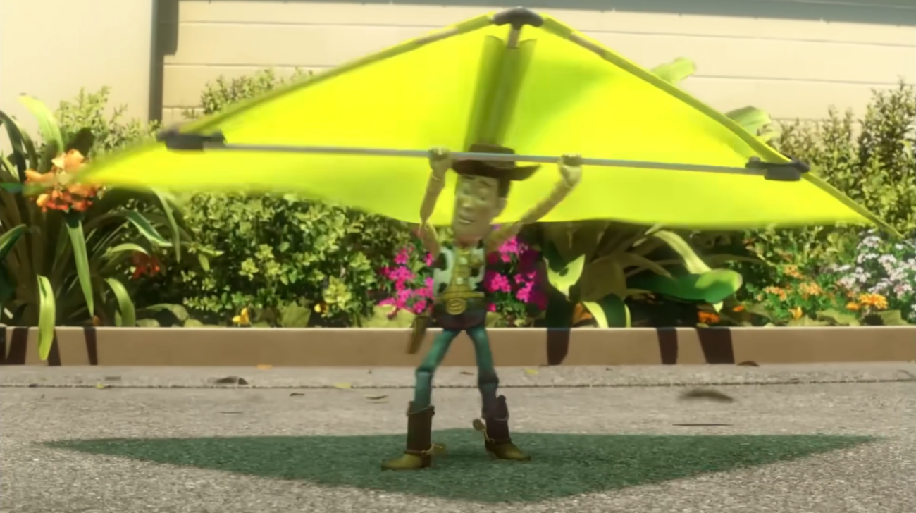 Woody standing on the ground holding a yellow toy paraglider in Toy Story, the first pose in the sequence